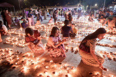 Buddhist devotees light earthern lamps at Botahtaung Pagoda to mark the full moon day of the Thadingyut festival in Yangon on October 6, 2025. 