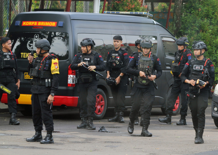 Members of the Jakarta Police Mobile Brigade’s bomb squad prepare on Oct. 7, 2025, to sweep for explosive materials at Mentari Intercultural School in South Tangerang, Banten. The bomb threat the school received earlier that day was determined to be a hoax after a three-hour inspection that yielded no explosives. 
