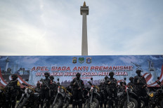 Police officers stand in formation during a roll call at National Monument Square in Central Jakarta on May 9, 2025, ahead of a two-week operation to curb thuggery and street brawls in the city. 