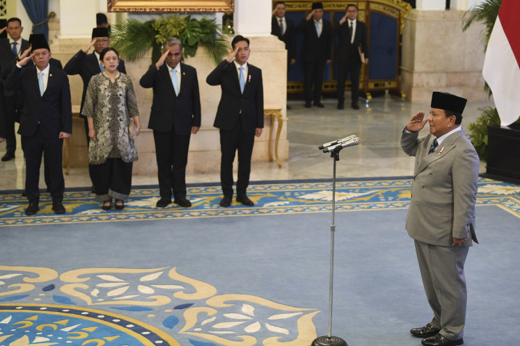 President Prabowo Subianto (right) salutes during an inauguration ceremony at the State Palace in Jakarta on Oct. 8, 2025.