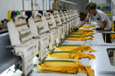 A worker operates an automatic embroidery machine on Oct. 7, 2025, at Anuhi Kahti Konveksi, Tangerang City, Banten.