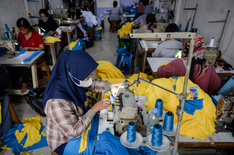 Workers produce garments at a factory in Tangerang city, Banten, on Oct. 7, 2025.