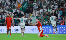 Saudi player Feras al-Brikan (right) celebrates his goal during the 2026 World Cup Asian fourth round qualifier match between Indonesia and Saudi Arabia at the King Abdullah Stadium in Jeddah, Saudi Arabia on Oct. 8, 2025.