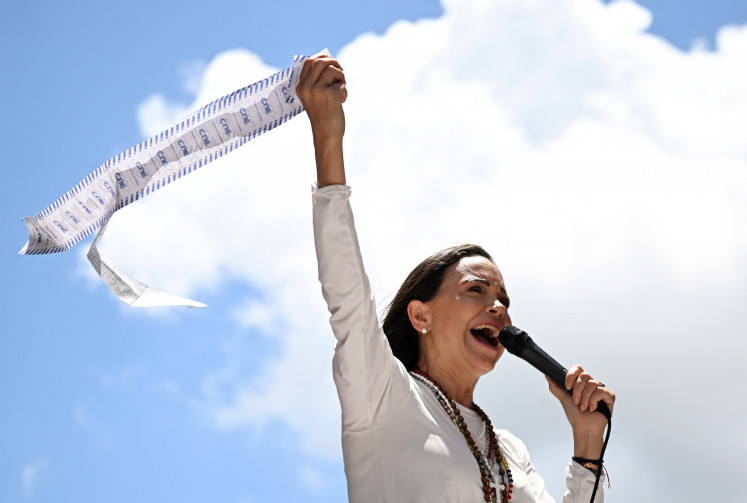 Venezuelan opposition leader Maria Corina Machado speaks to supporters while holding up electoral records during a rally in Caracas on Aug. 28, 2024. 