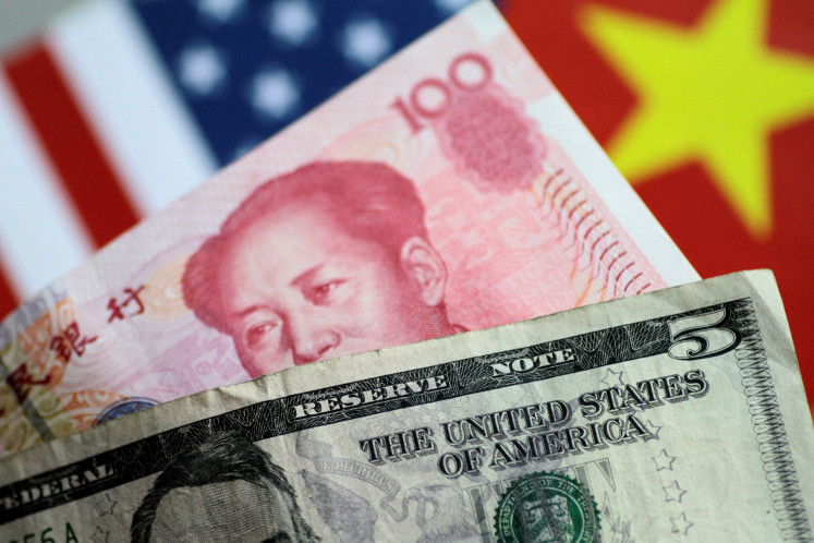 United States Dollar and China Yuan notes are seen in this illustration photo taken on June 2, 2017.