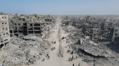People walk amid the destruction in Gaza City in the northern Gaza Strip on Oct. 11, 2025, a day after a ceasefire took effect. Israel declared a ceasefire in Gaza and began to pull back its forces on Oct. 10, as tens of thousands of exhausted Palestinians made their way back to their devastated homes.