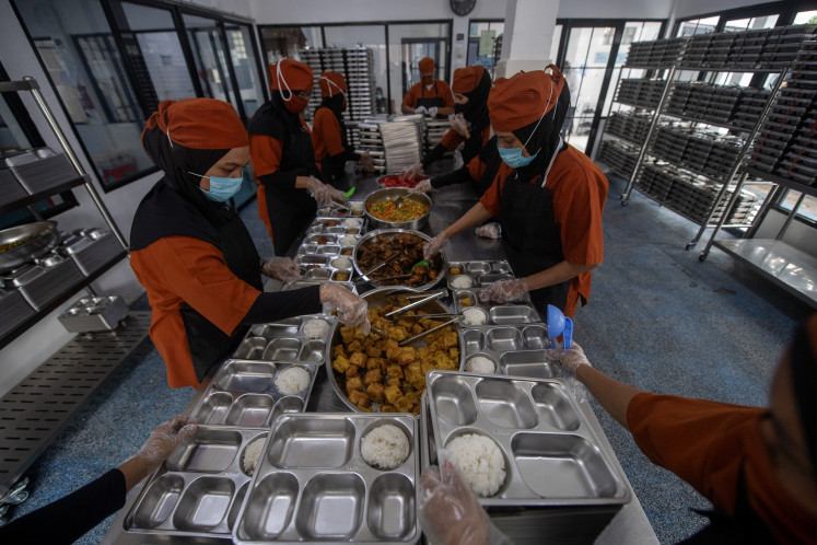 Workers prepare meal packages under the free nutritious meal program at the Plaju Ulu II nutrition fulfillment service unit (SPPG) in Palembang, South Sumatra, on Oct. 10, 2025. The kitchen disbursed 3,123 meal packages for eight schools in the area.