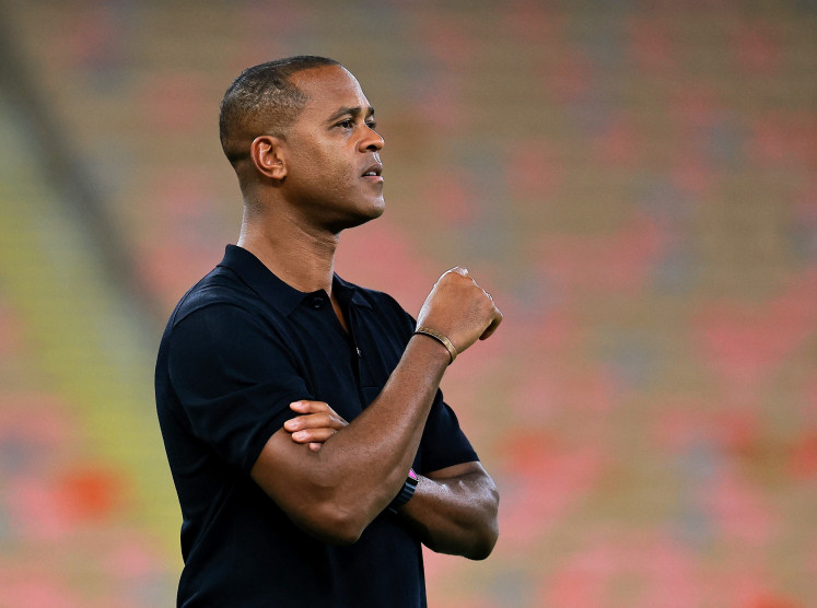 Indonesia senior men's soccer team head coach Patrick Kluivert watches the 2026 World Cup Asian fourth round qualifier match between Indonesia and Iraq at the King Abdullah Stadium in Jeddah, Saudi Arabia on Oct. 11, 2025.