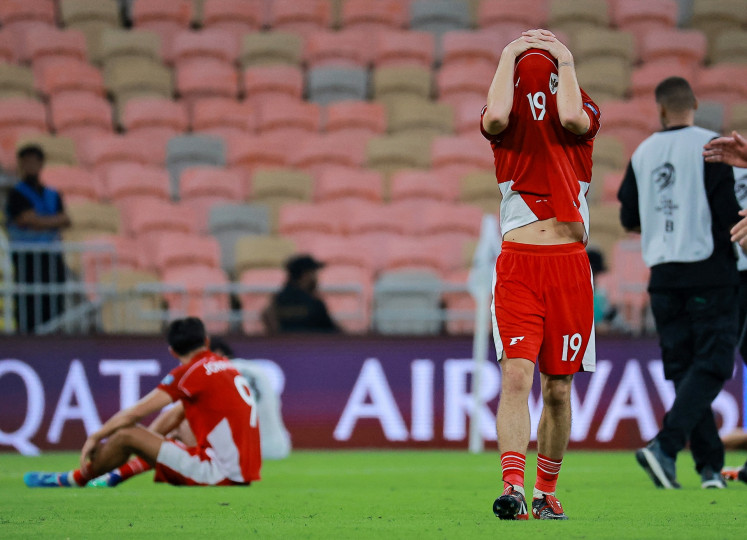 Indonesia senior men's soccer players Thom Haye (right) and Milliano Jonathans (left) react after the 2026 World Cup Asian fourth round qualifier match between Indonesia and Iraq at the King Abdullah Stadium in Jeddah, Saudi Arabia on Oct. 11, 2025.