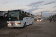 Buses with the International Red Cross emblem on them move towards the eastern Gaza Strip from Khan Yunis in southern Gaza on October 13, 2025, ahead of the release of Israeli hostages held by Hamas since the October 7 attacks two years ago. Under a ceasefire deal pushed for by US President Donald Trump, Hamas was to release the 47 remaining hostages -- living and dead -- in exchange for 250 Palestinian prisoners held in Israeli jails, along with 1,700 Gazans detained since the latest conflict broke out in October 2023.
