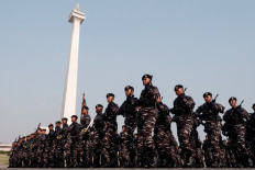 Indonesian Navy personnel walk next to the National Monument (Monas) during the celebration of the 78th anniversary of the Indonesian Military (TNI) in Jakarta on Oct. 5, 2023. 