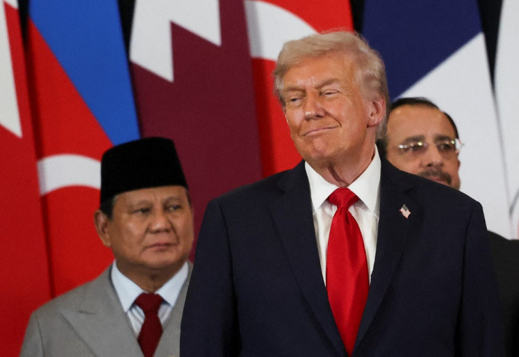 United States President Donald Trump (center) smiles as President Prabowo Subianto (left) watches during a summit on Gaza in Sharm el-Sheikh, Egypt on Oct.13, 2025. Prabowo attend the summit and witness the signing of a ceasefire deal between Israel and Palestinian militant group Hamas by guarantors Trump, Egyptian President Abdel Fattah el-Sisi and Qatari Emir Sheikh Tamim bin Hamad al-Thani.