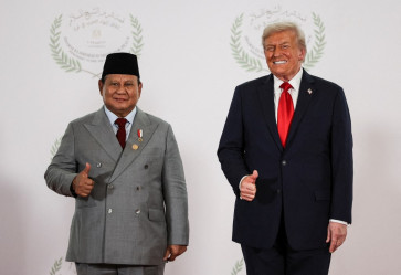 President Prabowo Subianto (left) poses for a photo with United States President Donald Trump  on Oct. 13 during a summit on Gaza in Sharm el-Sheikh, Egypt. During the summit, both leaders are caught in a 'hot mic' incident when they were apparently unaware of a microphone recording their exchange about a possible business deal.