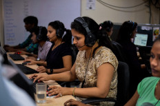 In this photograph taken on September 7, 2016, an Indian woman works at a call center of TravelKhana in Noida.