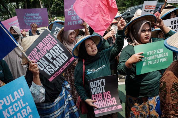 Residents of Pari Island take part in a protest demanding the government revoke a coastal reclamation permit (PKKPRL) granted for a private development project on their island, which they say threatens the marine ecosystem and worsens the climate crisis, in front of the Maritime Affairs and Fisheries Ministry building in Jakarta on Oct. 8, 2025.