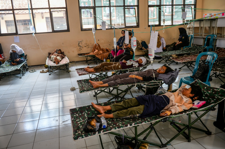 Students suffering from mass food poisoning after consuming free nutritious meal packages receive treatment at a health post established at the SMP 1 Cisarua state junior high school in West Bandung regency, West Java on Oct. 15, 2025. 