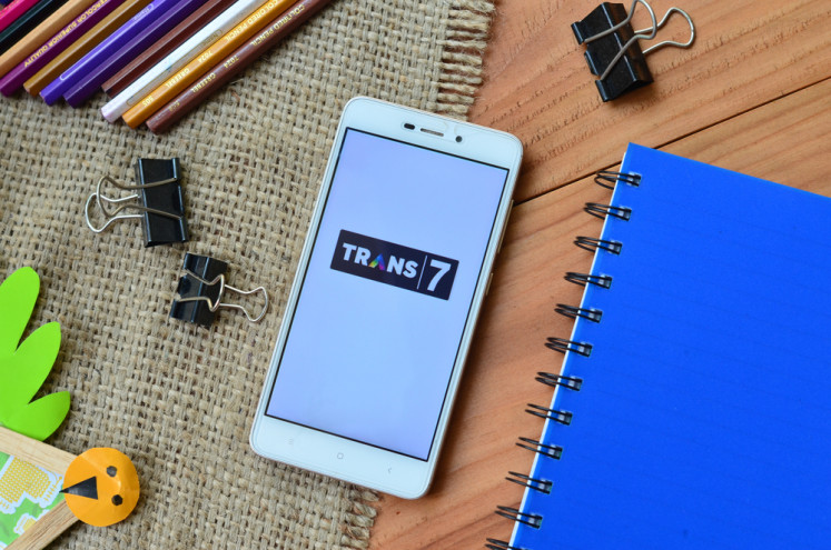The logo of private television company Trans7 is shown in a smartphone in this illustration photo.