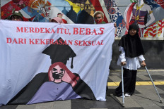 Activists from a women's anti-violence movement hold a banner that reads &ldquo;Independence is free from sexual violence&ldquo; during a protest against sexual harassment and violence against women in campuses outside the then-education and culture ministry in Jakarta on Feb. 10, 2020.