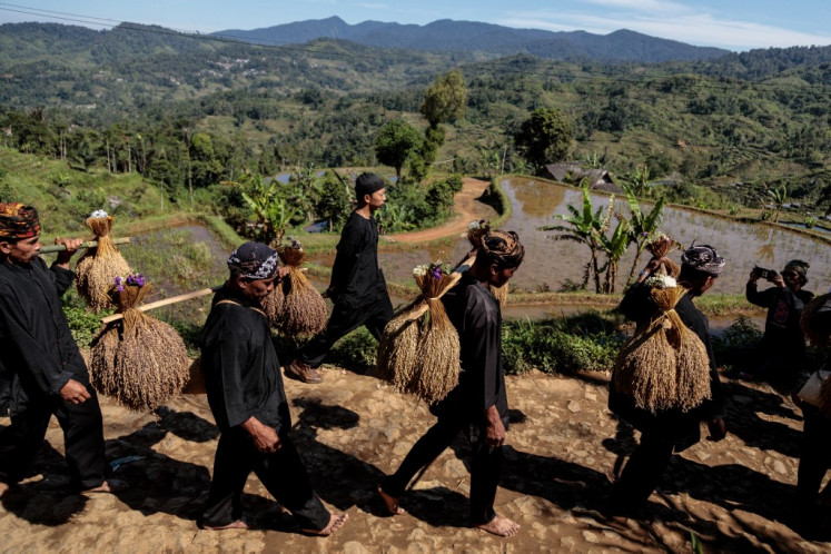 People of the Gelar Alam indigenous community carry bundles of rice stalks on Oct. 5 in a procession during the Seren Taun harvest festival in Sukabumi, West Java. The annual ceremony expresses gratitude for the year's harvest and seeks blessings for harmony with nature and ancestors.