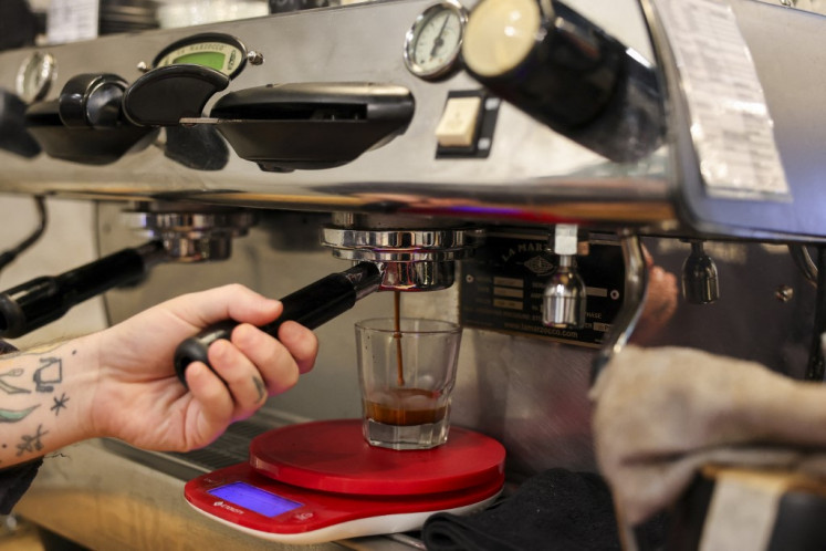A barista brews coffee at a coffee shop in New York City on October 16, 2025. 