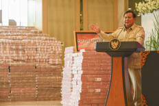 Pile it high: President Prabowo Subianto delivers a speech during the handover of funds seized from companies involved in a crude palm oil (CPO) corruption case at the Attorney General’s Office in Jakarta on Oct. 20, 2025. The AGO returned around Rp 13.2 trillion (US$825 million) to the state, recovered from illegal CPO export permits.