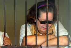British national Lindsay Sandiford reacts in her holding cell after she was sentenced to death for trafficking drugs worth an estimated US$2.14 million, following a hearing at a court in Denpasar, Bali, on January 22, 2013.