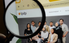 The logo of the Endowment Fund for Education (LPDP) is seen through a magnifying glass on Nov. 9, 2024.