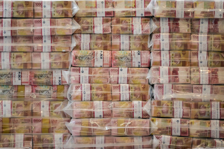 In this file photo dated Oct. 10, 2025, stacks of cash totaling Rp 13 trillion (US$785 million) are displayed in the lobby of the Attorney General&rsquo;s Office (AGO) in Jakarta during the handover of assets recovered from a corruption case involving crude palm oil export permits.
