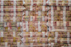 In this file photo dated Oct. 10, 2025, stacks of cash totaling Rp 13 trillion (US$785 million) are displayed in the lobby of the Attorney General&rsquo;s Office (AGO) in Jakarta during the handover of assets recovered from a corruption case involving crude palm oil export permits.