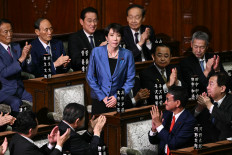 Liberal Democratic Party (LDP) president Sanae Takaichi stands up to acknowledge the applause after she was selected as Japan’s new prime minister during an extraordinary session of the lower house of the Diet on Oct. 21, 2025, in Tokyo.