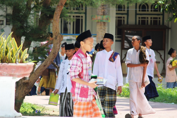 'Pesantren' (Islamic boarding school) students, locally known as 'santri', get ready to perform 'shalat dzuhur' (afternoon prayers) at the school’s mosque after attending classes. 