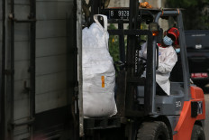 Cleaning up: A member of the Radiation Contamination Mitigation and Handling Task Force operates a heavy vehicle on Monday, October 20,  amid Cesium-137 decontamination efforts at the Modern Cikande Industrial Estate in Serang regency, Banten. Authorities have removed nearly 250 tonnes of material contaminated with Cesium-137 from the Cikande industrial hub while residents are being relocated.