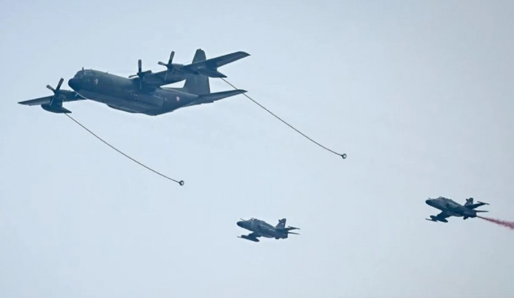 An Indonesian Air Force Hercules C-130J demonstrates an aerial refueling operation of T-50i aircraft during the 80th anniversary celebration of the Indonesian Military (TNI) in Jakarta on Oct. 5, 2025.