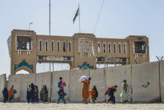 Afghan refugees deported from Pakistan arrive with their belongings at the zero point border crossing between Afghanistan and Pakistan in the Spin Boldak district of Kandahar province, Afghanistan on Oct. 19, 2025.