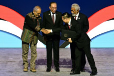 Timor Leste's President Jose Ramos-Horta (left) shakes hands with ASEAN Secretary-General Kao Kim Hourn, as Malaysia's Prime Minister Anwar Ibrahim (second from left) and Timor Leste's Prime Minister Xanana Gusmao (back right) watch, after East Timor joined the Association of Southeast Asian Nations (ASEAN) during the ASEAN Summit in Kuala Lumpur on October 26, 2025. Timor Leste joined the Association of Southeast Asian Nations (ASEAN) bloc on October 26 as its 11th member state after 14 years of campaigning. (Photo by / )