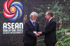 Malaysia's Prime Minister Anwar Ibrahim (right) greets Timor-Leste Prime Minister Xanana Gusmao on Sunday as he arrives to attend the 47th ASEAN Summit, in Kuala Lumpur.