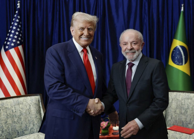 This handout picture released by the Brazilian Presidency shows Brazil's President Luiz Inacio Lula da Silva (right) shaking hands with US President Donald Trump during a bilateral meeting on the sidelines of the 47th Association of Southeast Asian Nations (ASEAN) Summit in Kuala Lumpur on October 26, 2025. 