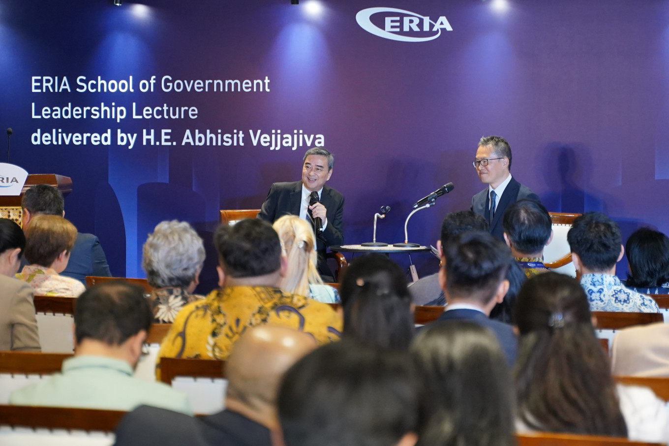 Former Thai prime minister Abhisit Vejjajiva (center left) answers questions from the audience while dean and managing director of the School of Government (SOG) at the Economic Research Institute for ASEAN and East Asia (ERIA), Nobuhiro Aizawa (center right) looks on in Jakarta on Oct. 22, 2025. Abhisit shared insights into his pivotal political decisions and reflected on the evolving political dynamics in Southeast Asia.