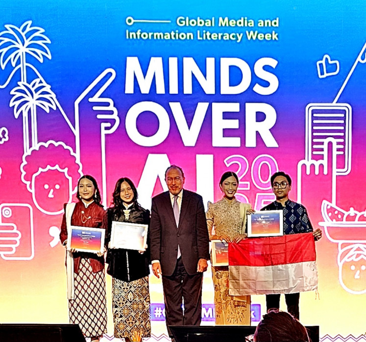 Seen in the picture with Tawfik Jelassi (center), UNESCO's assistant director-general for communication and information, are (left to right): Wynneth Artdelyn Jees, Jesseline Carolee Sabas, Vinnidhiaty Gradelyn Jees and Jonathan Emmanuel Saragih. The team from the Bandung Institute of Technology won a UNESCO Youth Hackathon award on Oct. 25, 2025 for a mobile app designed to help combat misinformation.