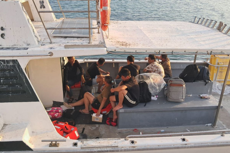 Seven Chinese nationals are pictured on board an unidentified vessel in Rote Ndao regency, East Nusa Tenggara (NTT), in this undated picture released by the NTT Police. The Rote Ndao Police intercepted the boat along with three Indonesian crew on Oct. 26, 2025, following a report made by local fishermen. 