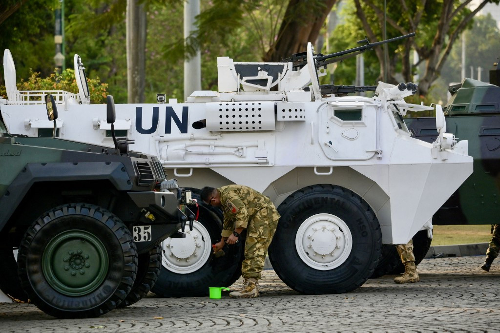 An Indonesian Military (TNI) trooper clean the tires of an Anoa 2 armored personnel transport vehicle, produced by state owned arms manufacturer PT Pindad, used for peacekeeping forces under the United Nations during a rehearsal on Oct. 3, 2023, for the 78th TNI anniversary in Jakarta.