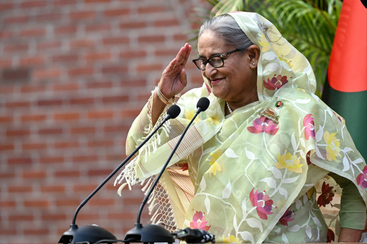 Then-Bangladeshi Prime Minister Sheikh Hasina gestures as she receives greetings from media and election observers during a press conference in Dhaka on Jan. 8, 2024, the day after her Awami League party won the 12th parliamentary election.