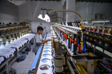 Workers produce garments at the Tectona textile factory in Pameungpeuk, Bandung regency, West Java, on Oct. 29, 2025.