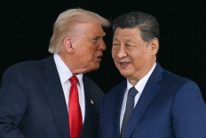 United States President Donald Trump (left) talks to Chinese President Xi Jinping as they shake hands after their talks at the Gimhae Air Base, located next to the Gimhae International Airport in Busan, South Korea on Oct. 30, 2025. Trump and Xi opened on Oct.  30 their first face-to-face meeting in six years, seeking a truce to end a trade war that has roiled the world economy.