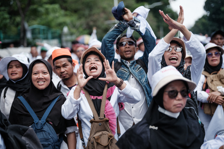 Loud and proud: Demonstrators react as the music pauses during a labor rally calling for better working conditions on Oct. 30, 2025, near the National Monument (Monas) park in Central Jakarta.