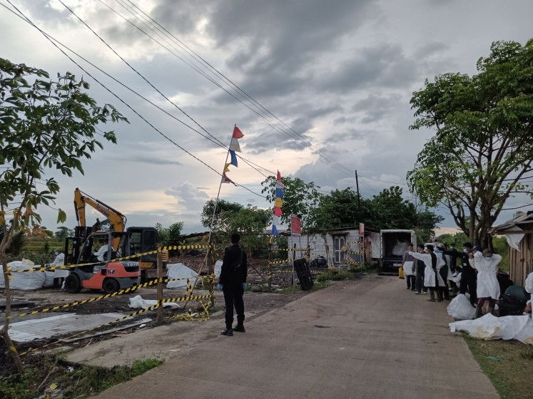 Specialist personnel in protective gear carry out decontamination on Oct. 29, 2025, at a vacant plot in Cikande district, Serang regency, Banten, following the detection of cesium-137, a radioactive substance.