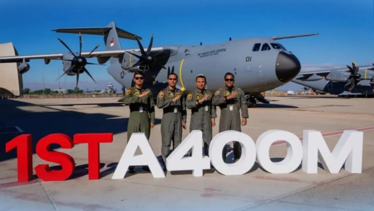 Air Force pilots pose in front of an Airbus A400M with tail number A-4001 in Seville, Spain, in this undated picture released on Oct. 27, 2025. The aircraft is the first of two aircraft ordered by Indonesia.