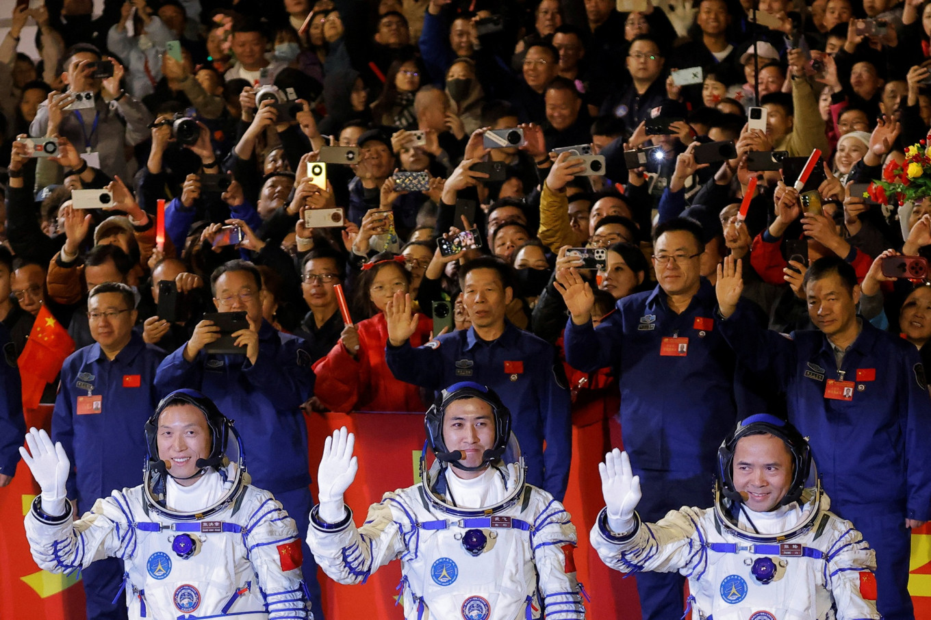 Astronauts Zhang Hongzhang (front, from left), Wu Fei and Zhang Lu wave during a see-off ceremony before taking part in the Shenzhou-21 spaceflight mission to China's Tiangong space station, at Jiuquan  Satellite Launch Center, near Jiuquan, Gansu province, China, on Oct. 31, 2025.