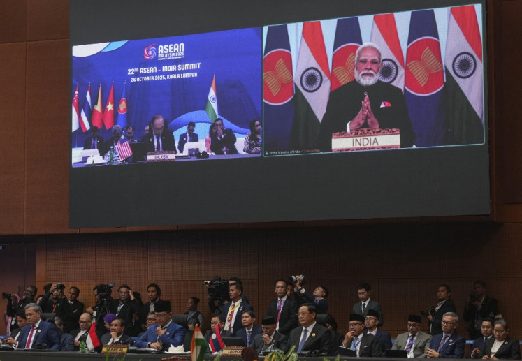 India's Prime Minister Narendra Modi appears on a screen to deliver a speech remotely on Oct. 26 as other leaders attend the 22nd ASEAN - India Summit during the 47th ASEAN Summit in Kuala Lumpur.