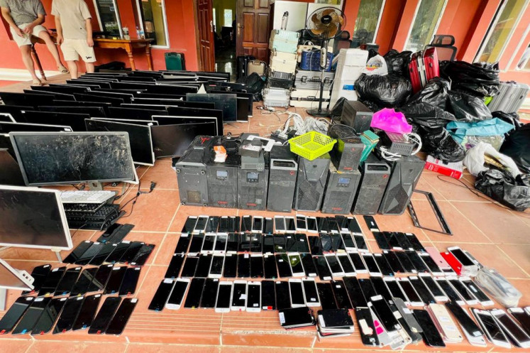 This photo taken on July 17 and released on July 18 by Agence Kampuchea Presse (AKP) shows computers, smartphones and other equipment seized during a raid on a scam center in Kandal province, Cambodia. The number of suspects arrested in the crackdown on internet scam centers has risen to 2,000, a government minister told AFP on July 18.